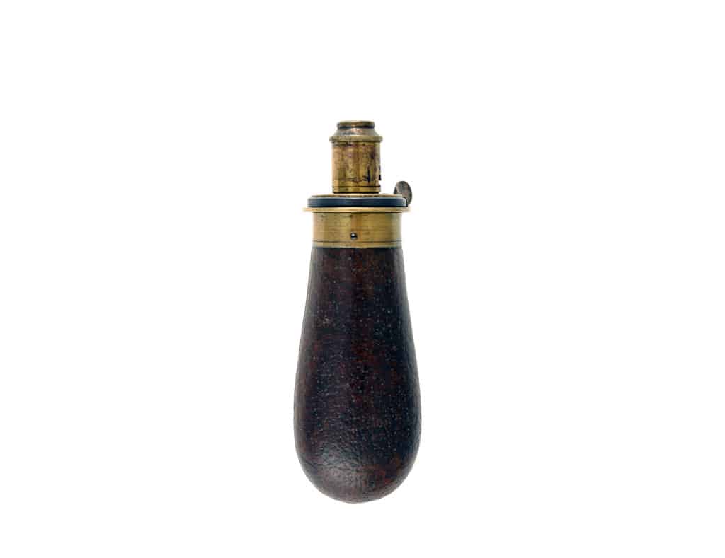 A Small Brown Leather Covered Flask.